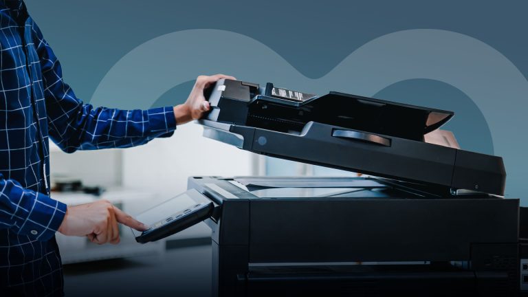 A man using a photocopier, behind a Volvo and Keyloop logo.