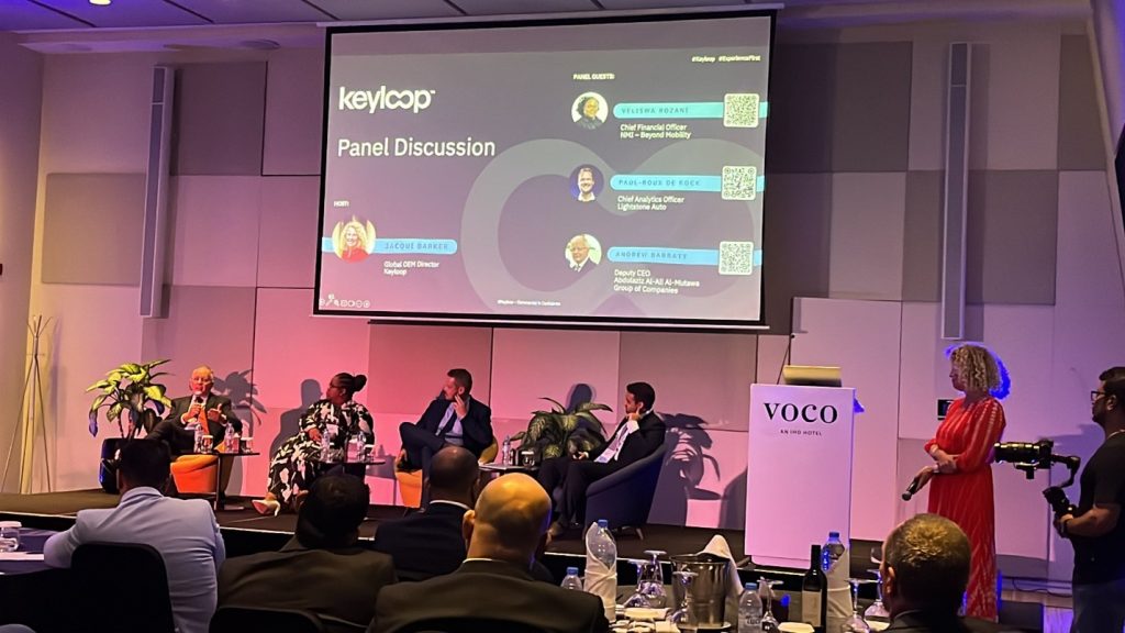 Panel discussion from day one. From left to right, Andrew Barratt – Deputy CEO for Abdulaziz Al-Ali Al-Mutawa Group of Companies, Veliswa Rozani – Chief Financial Officer for NMI - Beyond Mobility, Paul-Roux De Kock – Chief Analytics Officer for Lightstone Auto , and Joseph Salem – Partner for Arthur D. Little Middle East , and host Jacqui Barker – Global OEM Director for Keyloop.