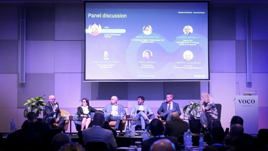 Panel discussion from day two. From left to right, Andrew Barratt – Deputy CEO for Abdulaziz Al-Ali Al-Mutawa Group of Companies, Rana Abbadi – VP Operations for Ezz Elarab Group, Zakaria Elnaggar – Group CIO for Mohamed Yousuf Naghi Motors Co., Abdulla Al-Attas – GM of IT, Business & Digital Transformation for SAMACO Motors, Paul-Roux De Kock – Chief Analytics Officer for Lightstone Auto , and host Jacqui Barker – Global OEM Director for Keyloop.